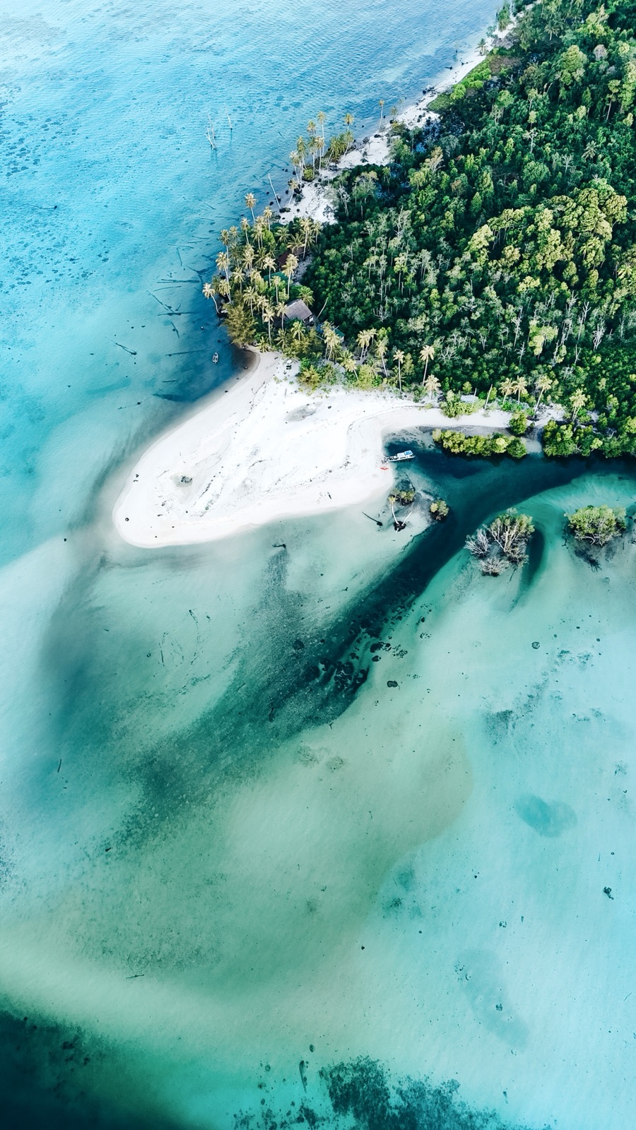 Aerial view of a secluded cove and moored boats off the island, Mentawai Islands, Indonesia